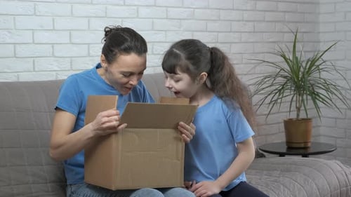 Mother and Daughter Opening a Surprise Gift Together