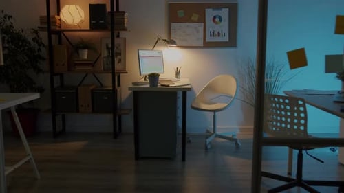Zoomout of Modern Open Space Office with Workplaces and Equipment and No People at Night