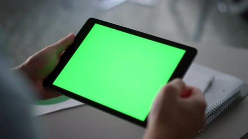 Businessman Swiping Tablet Pad Green Screen Analyzing Corporate Data in Office