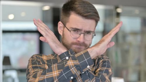 Portrait of Young Designer Saying No with Hand Gesture