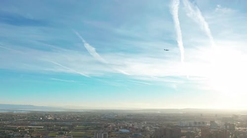Airplane Flying Against a Blue Sky Background