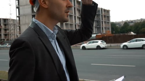 Engineer in Suit and Helmet Presents Project