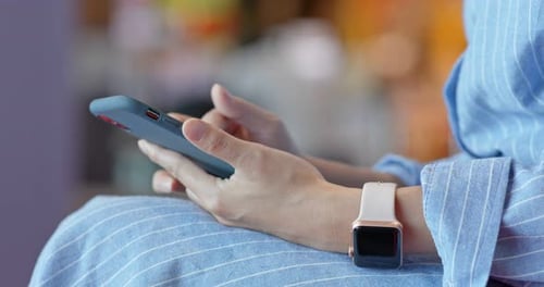 Close up of woman use of mobile phone inside shopping center