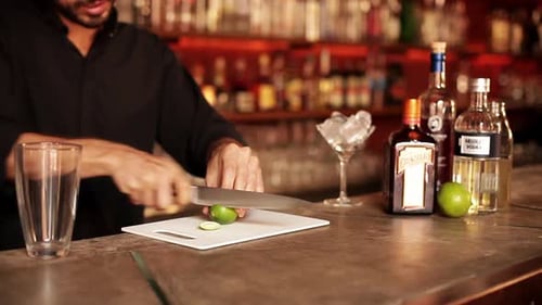 Bartender Slicing a Lime for Cocktail Preparation