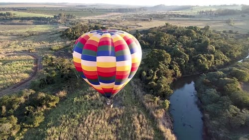Hot Air Balloon Floating over Rural Landscape