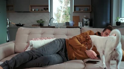 Man Relaxing with Dog on Couch at Home