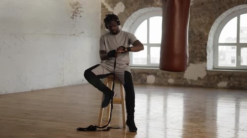 Man Wrapping Hands, Preparing to Box in Studio