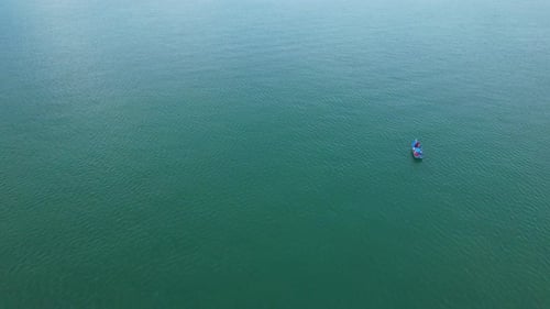 Fishing boat sailing in the sea near river mouth