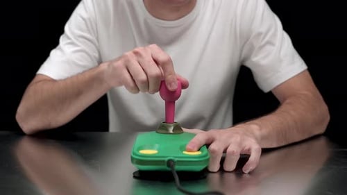 Young Adult Plays Vintage Joystick Game Controller