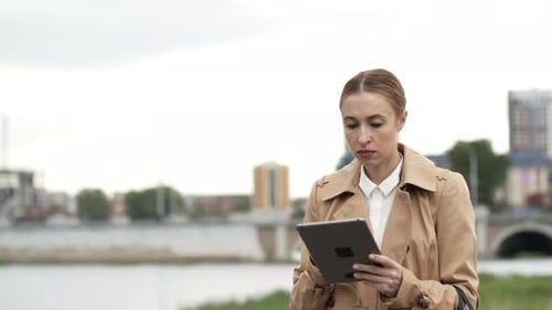 Woman Using Tablet in City