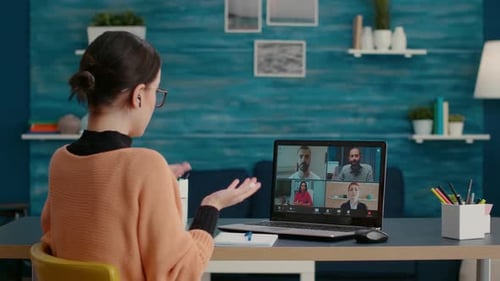 College Student Using Laptop to Attend Remote Videocall Webinar