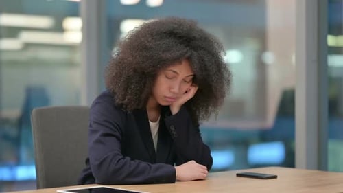 Woman Resting Her Head at Desk in Office