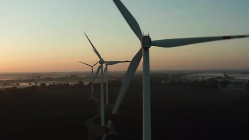 Aerial View of Wind Turbines at Dawn in the Fog