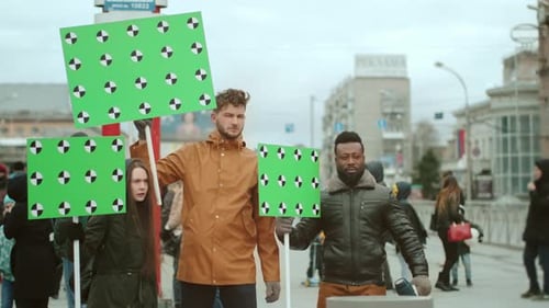 People Holding Green Screen Signs in City