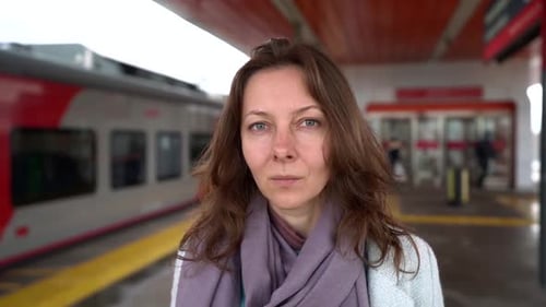 Portrait of Cheerful Woman on Railway Station, Waiting Someone and Looking at Camera