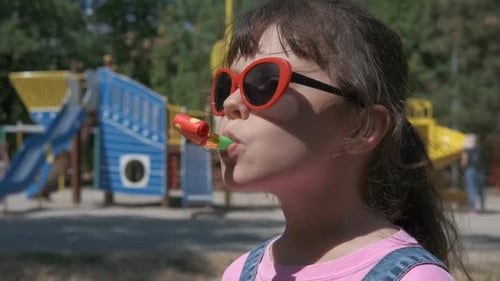 Little Girl with Party Favor Celebrates Outdoors