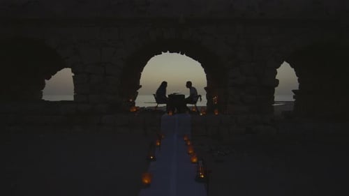 Romantic Dinner on Beach at Sunset with Candles