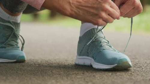 Close up of woman tying shoe laces