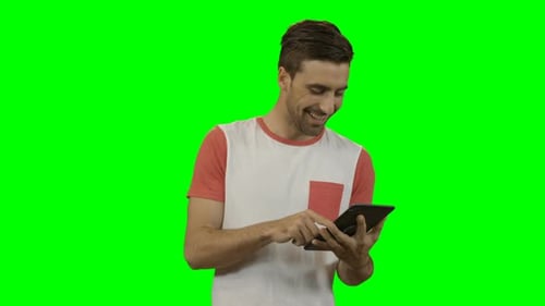 Man Interacting with Tablet on Green Screen