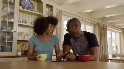 Couple Laughing Together at Kitchen Counter