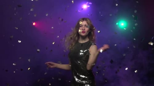 Woman Dancing in Sequined Dress with Confetti
