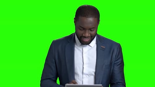 Man Uses Tablet on Chroma Key Background