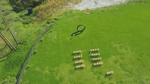 Elegant Wedding Venue and Empty Chairs on Meadow Upper View