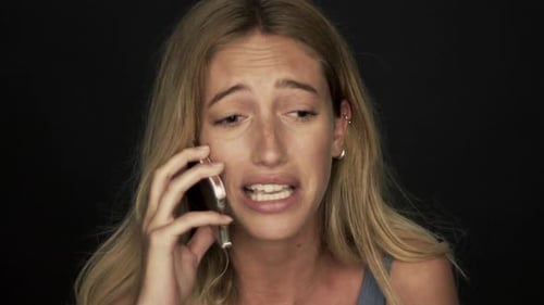 Distraught Woman Talking on Phone Close Up