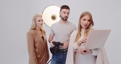 Team Reviews Images in Studio Photo Shoot