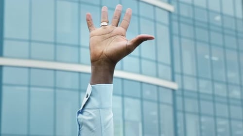 Hand Raises Up Clenching Into A Fist