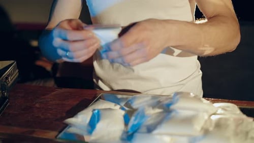 Drug Trafficker is Packing Drugs into Suitcase