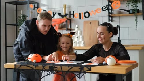 Family Creating Halloween Decorations at Home