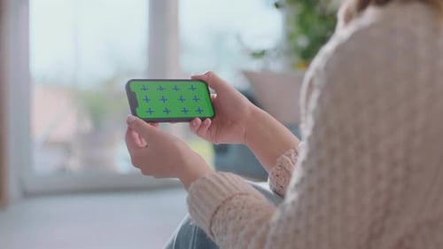 Holding Smartphone with Green Screen in Bright Room