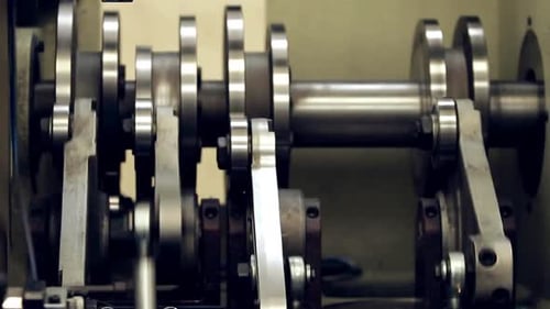 Close Up of Metal Crankshaft and Connecting Rod Mechanism in an Industrial Machine
