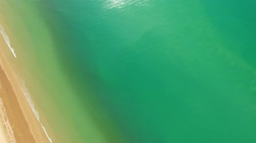 4K Aerial view top view of drone, sea waves and beautiful sand beach.