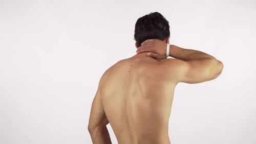 Rear view Shot of a Muscular Male Athlete Suffering From Neck and Back Pain
