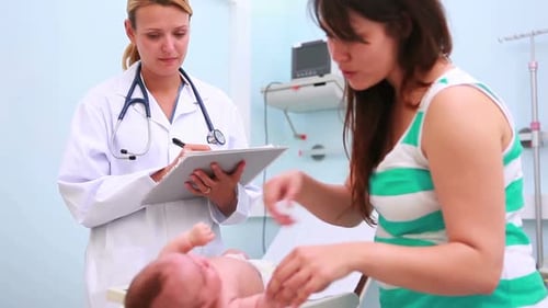 Caring Doctor Examines Newborn Baby at Hospital