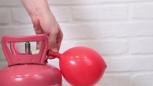 Filling a Red Balloon with Helium Gas