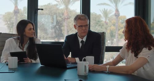 Colleagues team having a business meeting at the office, discussing their new project. Slow motion