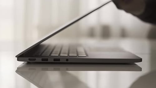 Opening Laptop and Typing at a Desk