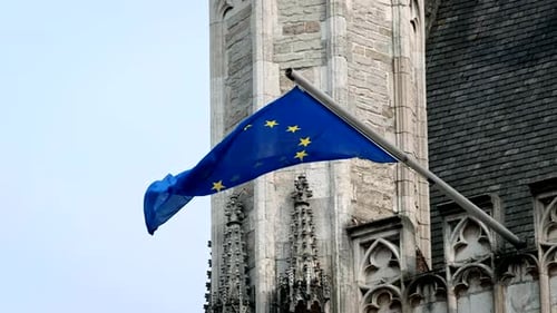 European Union Flag Waving Beside Stone Building