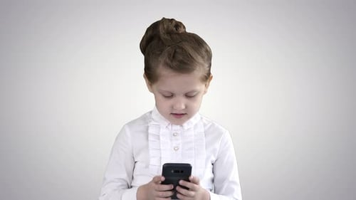 Girl Using a Smart Phone Indoors
