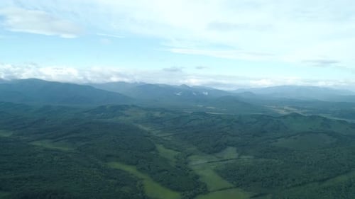 Aerial Drone View Beautiful Natural Scenery of Green Hills with Mountains in Background