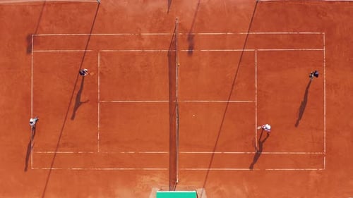 Aerial View Players Are Playing Tennis on Orange Court