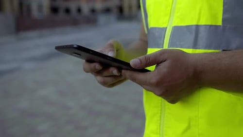 Close Up View of Man's Hands That Typing on the Black Tablet