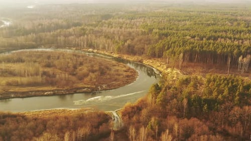 Aerial View Of Forest Woods And Partly Frozen River Landscape In Sunny Late Autunn Day
