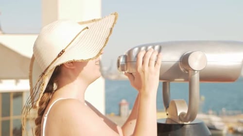 Woman Looking Through Seaside Binoculars on Sunny Day