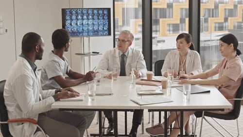 Medical Professionals Team Meeting In Modern Office