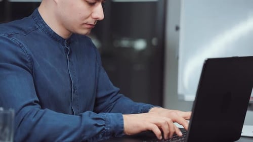 Businessman Working in Office and Typing on Laptop