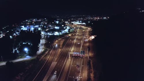 Aerial night shot of a bust highway with traffic in all lanes and street lights